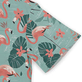 Tropical flamingo print fabric with pink birds, green leaves.