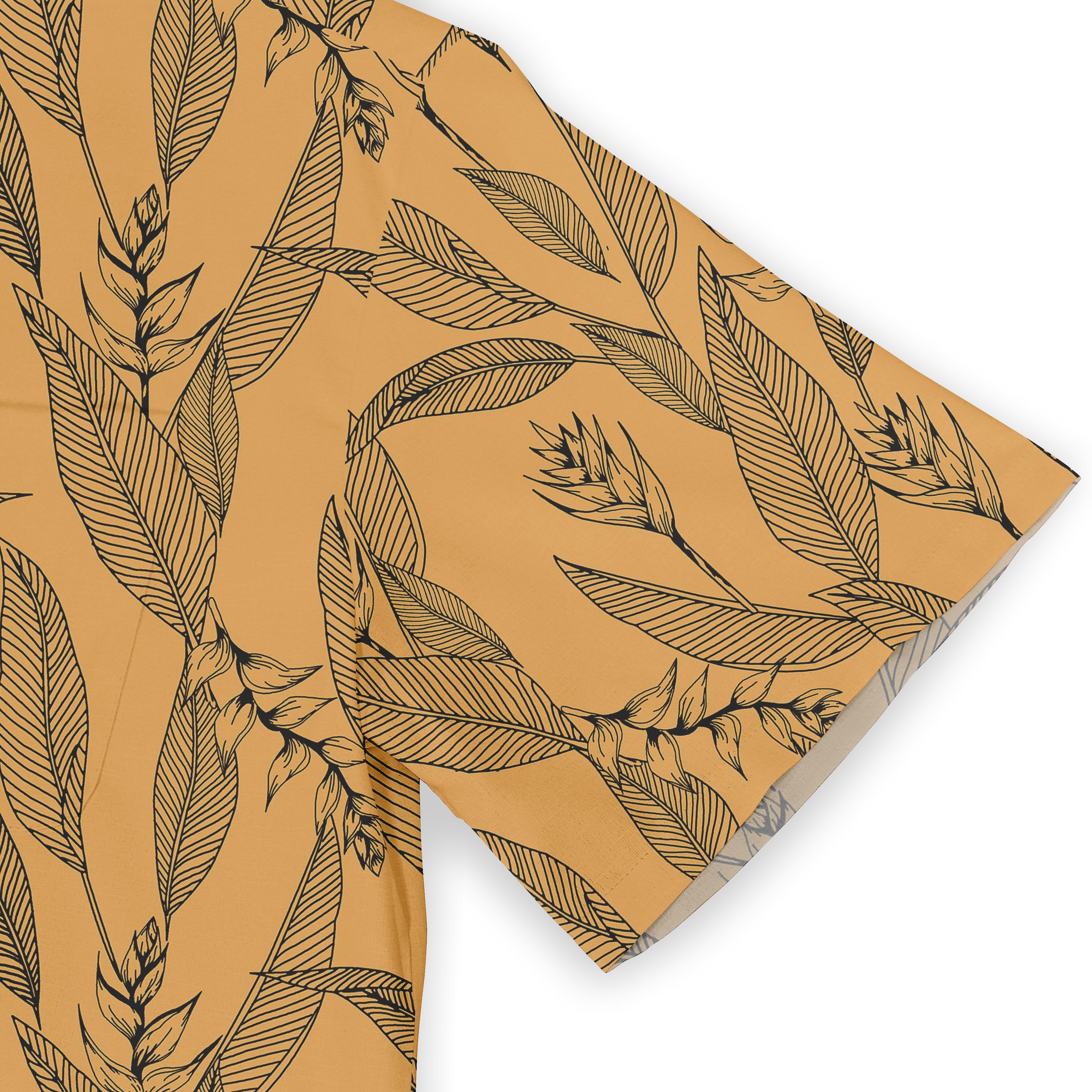 Mustard yellow fabric with black leaf and floral pattern, folded.