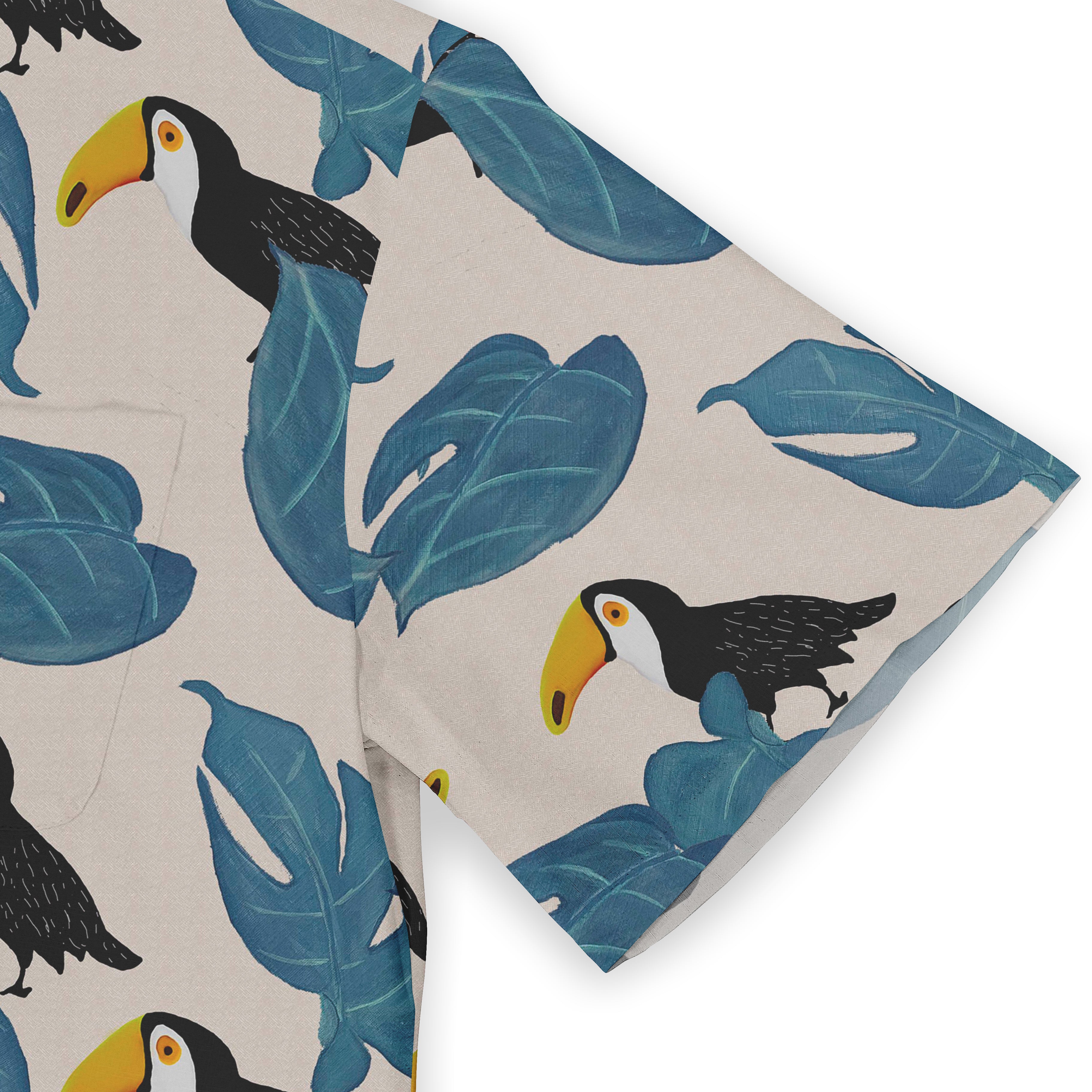 Toucan and leaf patterned fabric in blue, black, yellow, and beige.