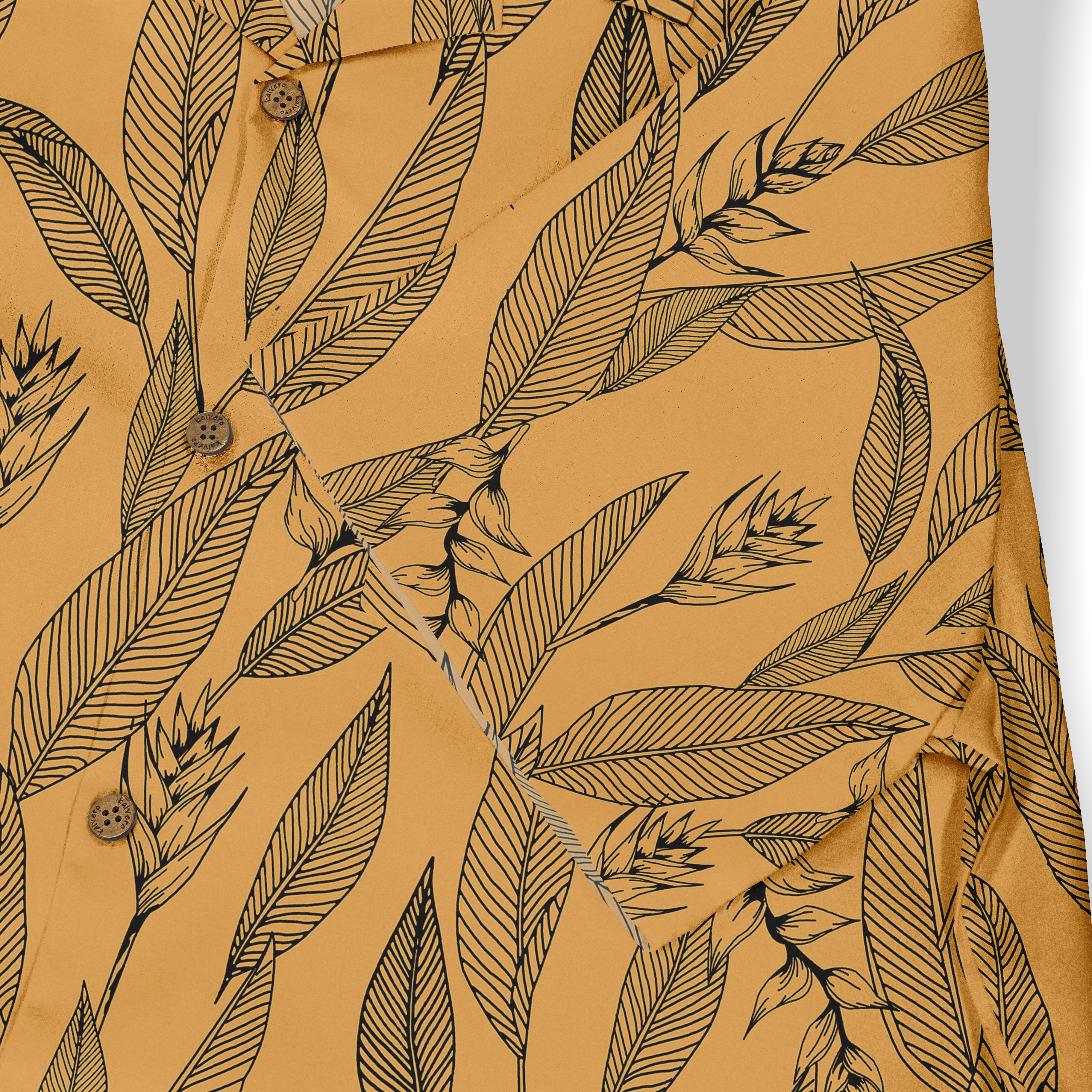 Mustard yellow shirt with black leaf pattern and wooden buttons.