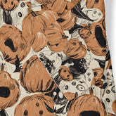 Halloween-themed shirt with pumpkin and ghost print, featuring.