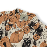 Halloween-themed shirt with pumpkin and ghost print, featuring.