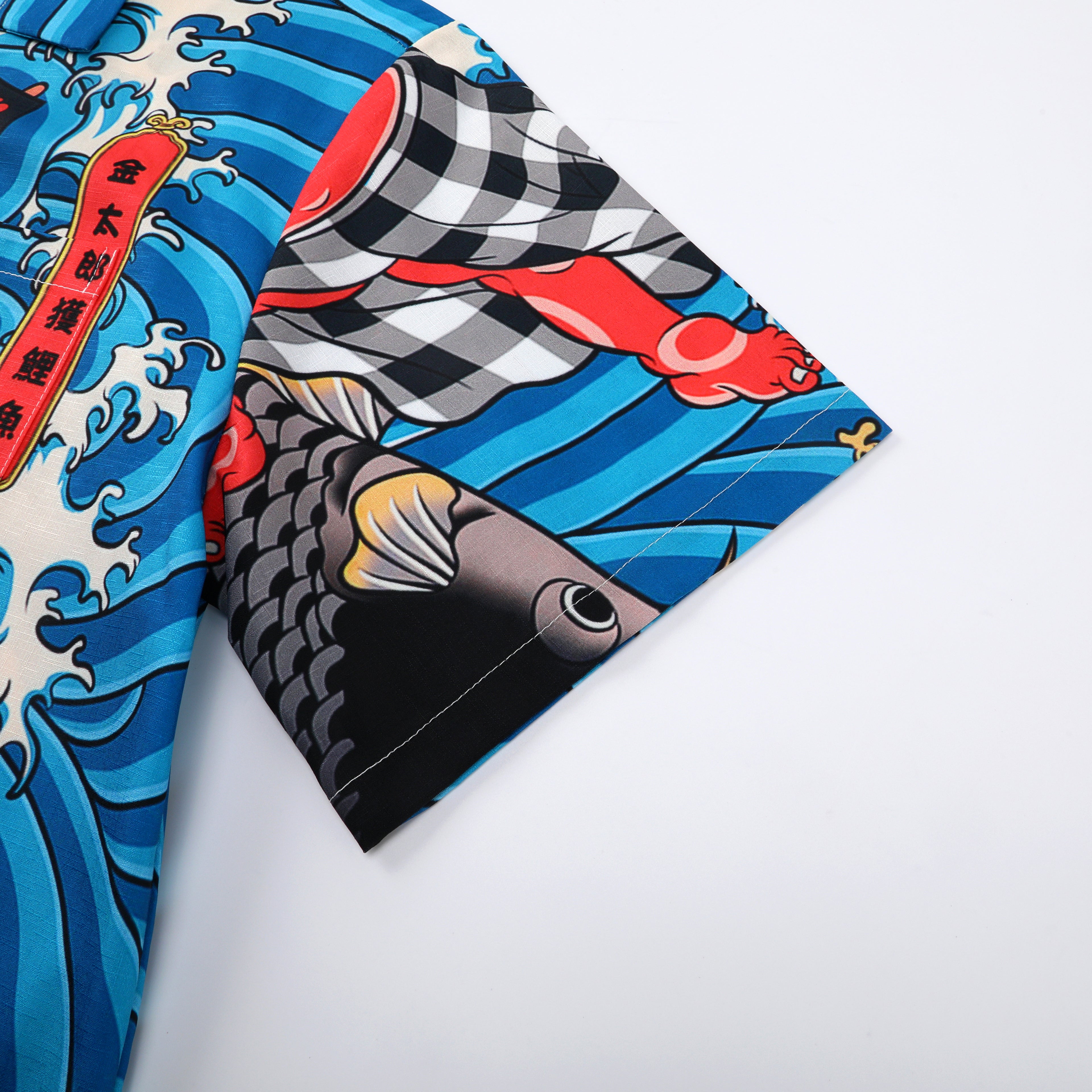Colorful shirt with fish and waves design, blue background.