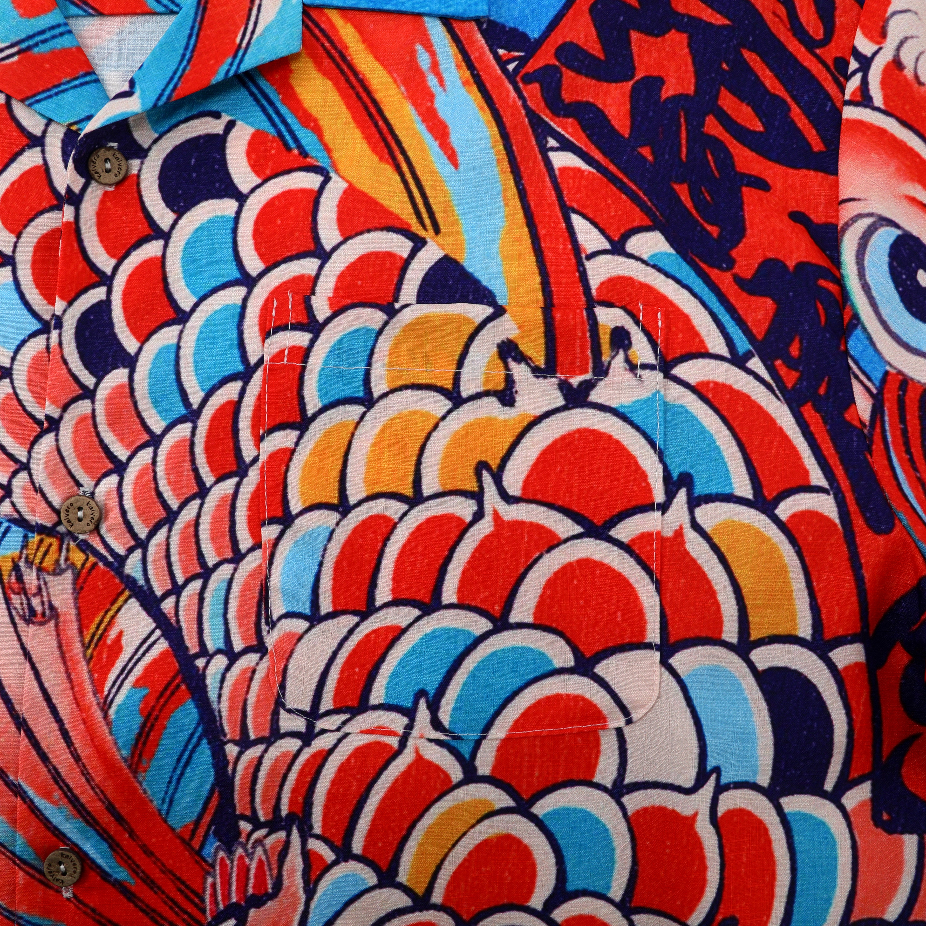 Vibrant red, blue, and yellow patterned shirt with scale-like design.
