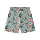 Green shorts with pink flamingo and leaf pattern.