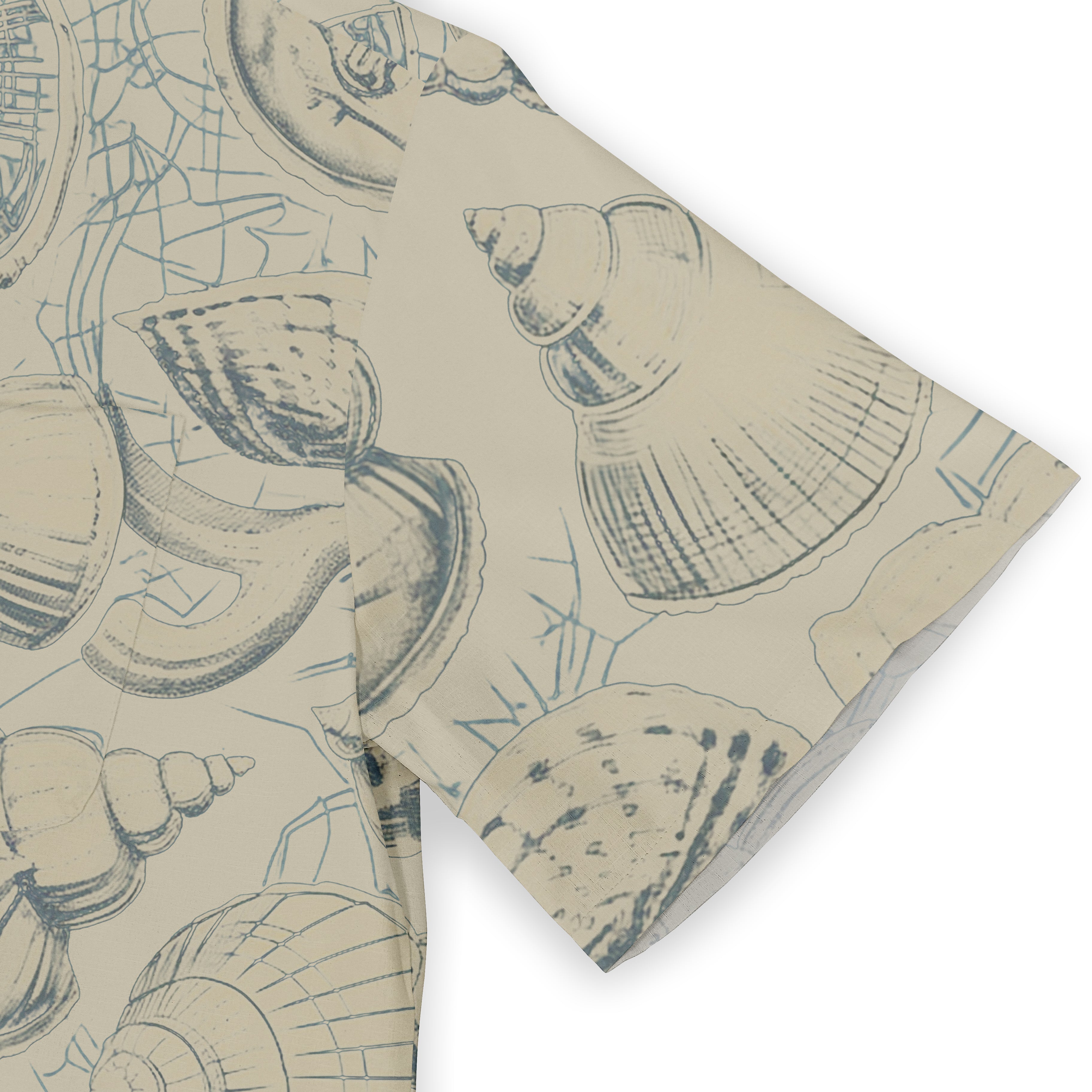 Beige fabric with blue seashell and coral patterns, folded to show.