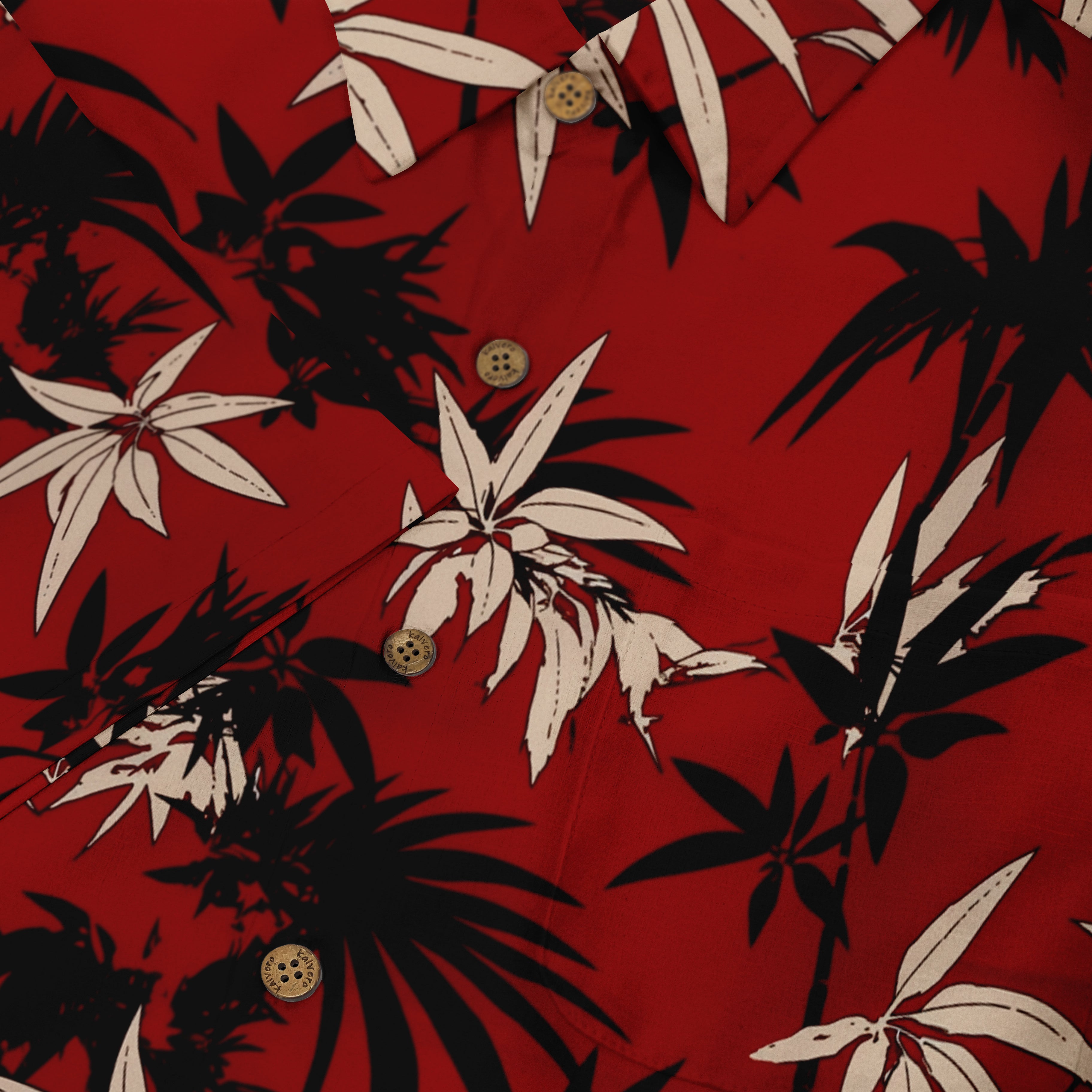 Red shirt with black and white tropical leaf pattern, featuring.