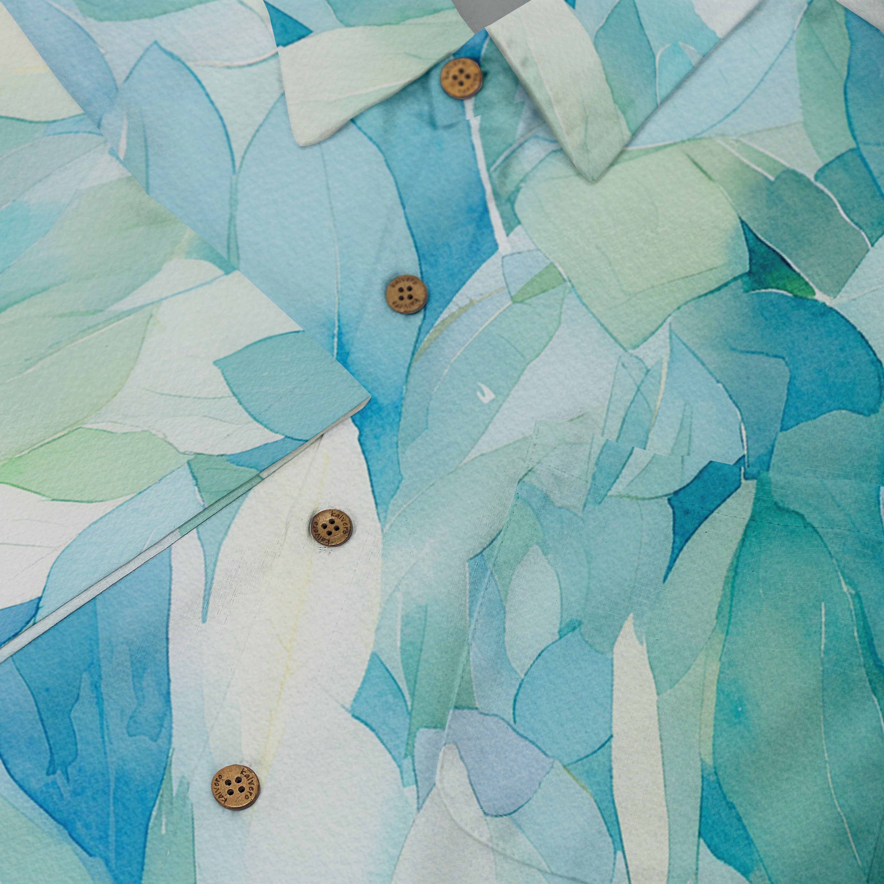 A vibrant blue and green leaf-patterned shirt with wooden buttons.