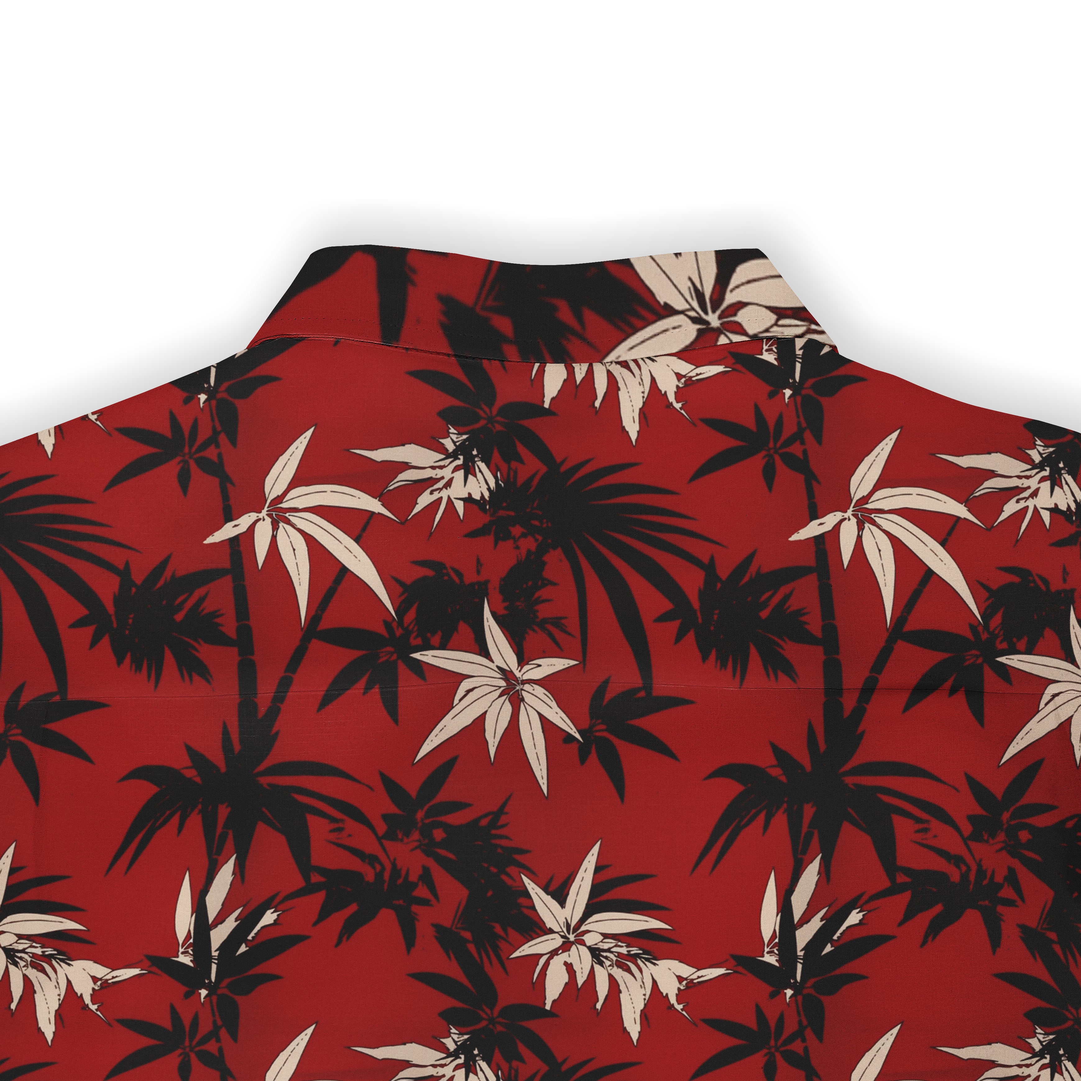 Red shirt with black and white tropical leaf pattern, featuring.