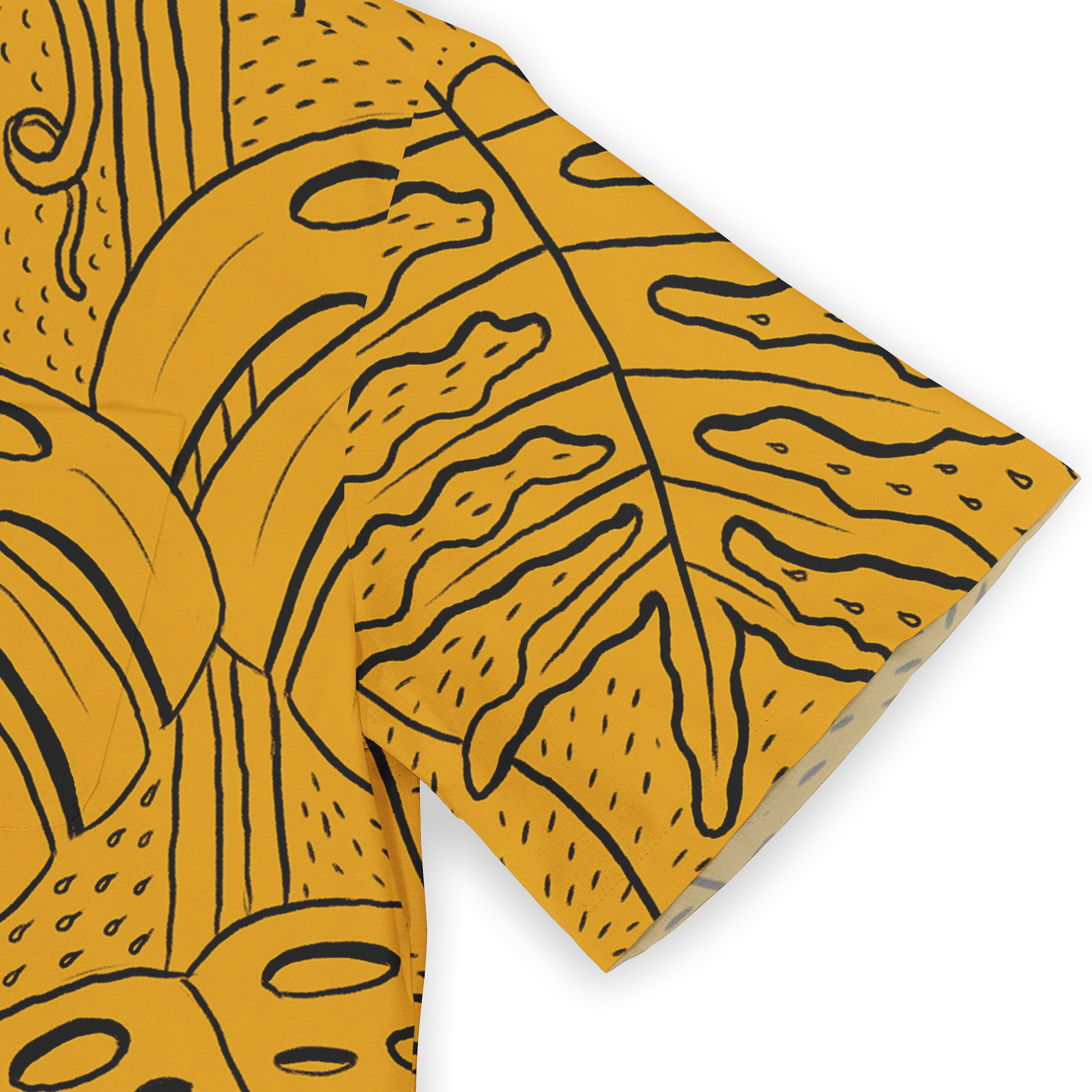 Yellow fabric with bold black abstract leaf patterns, folded.