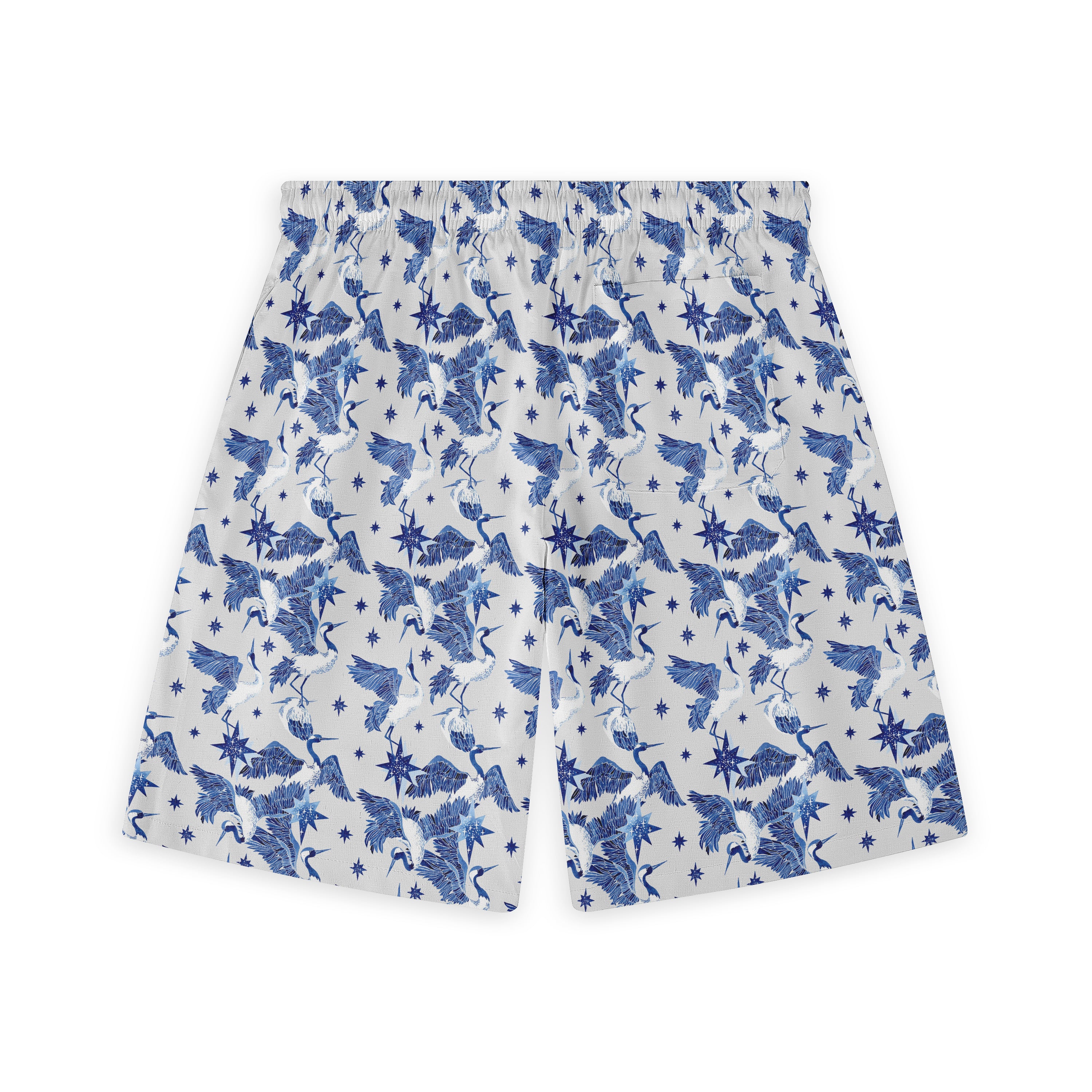 Blue and white patterned shorts featuring cranes, stars.