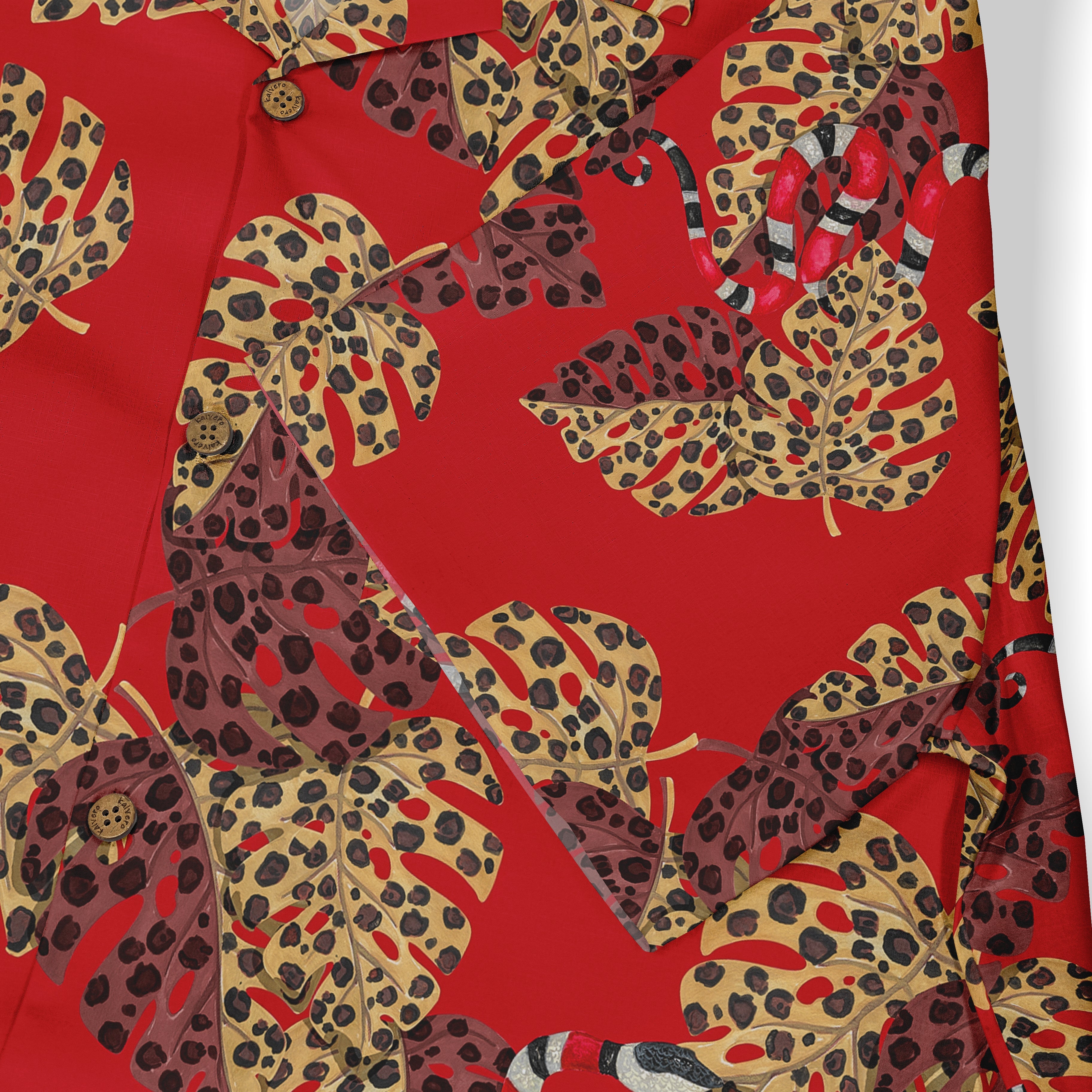 Red shirt with tropical leaf and snake print, featuring bold colors.