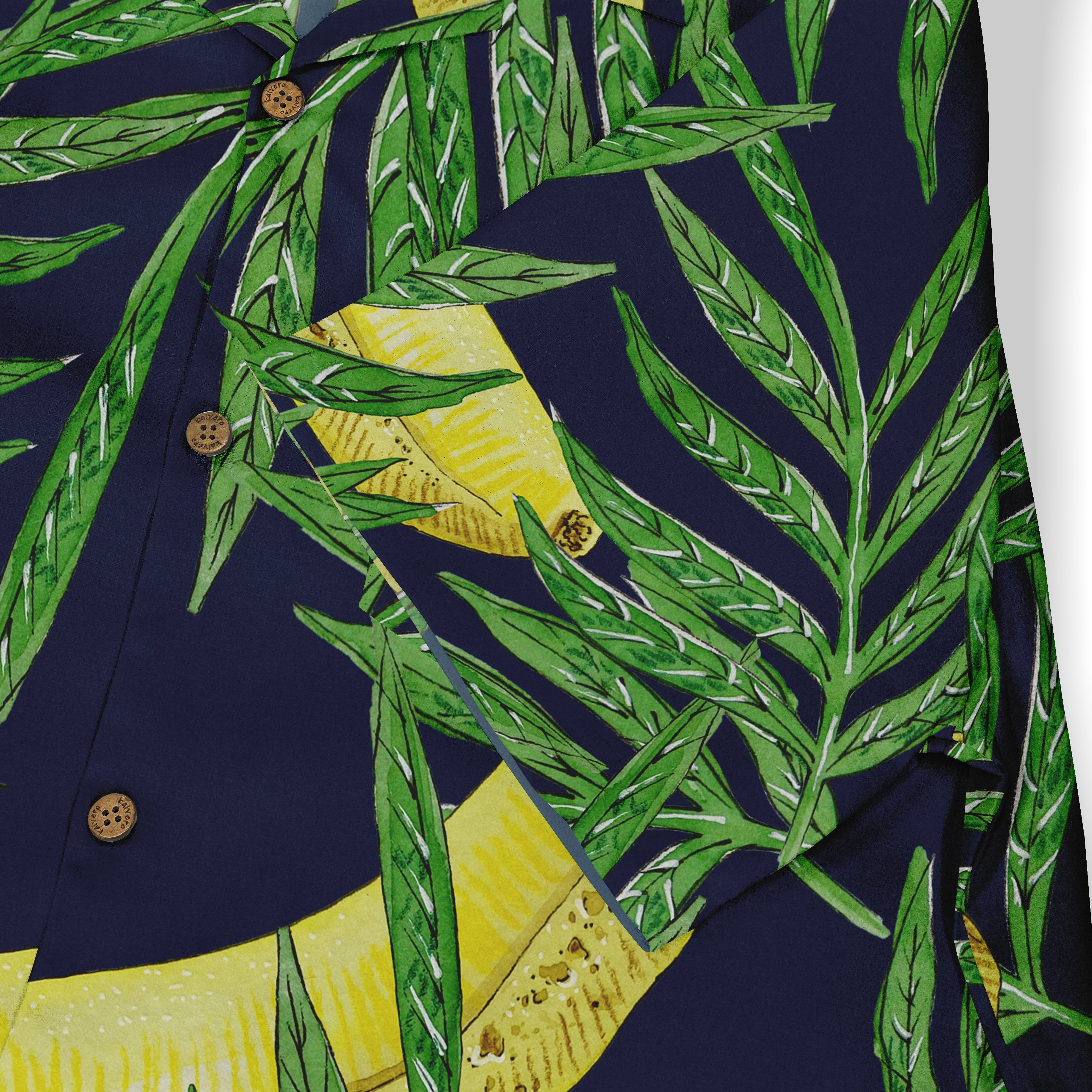Navy blue shirt with vibrant green palm leaves and yellow banana.