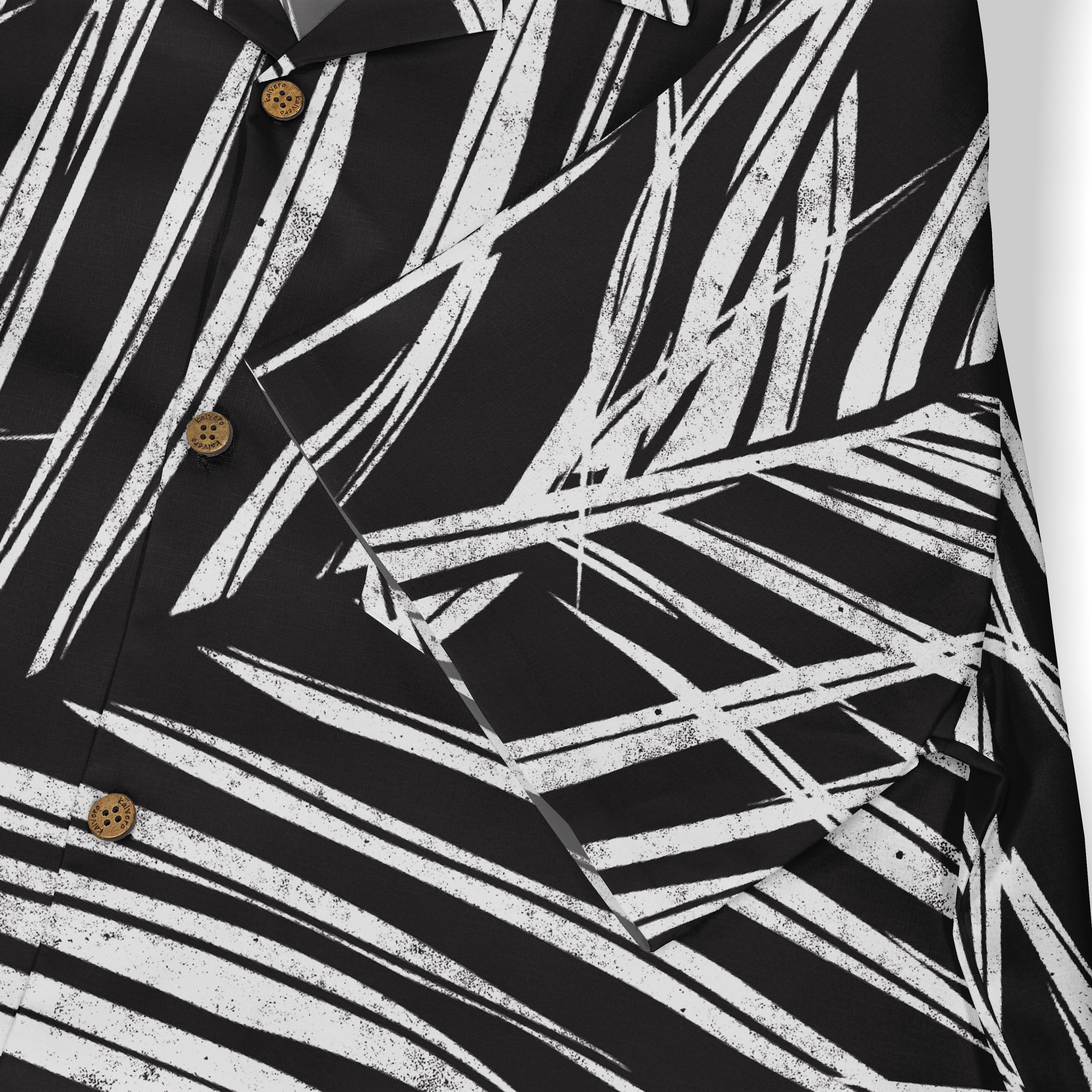 Black shirt with white abstract leaf pattern and wooden buttons.