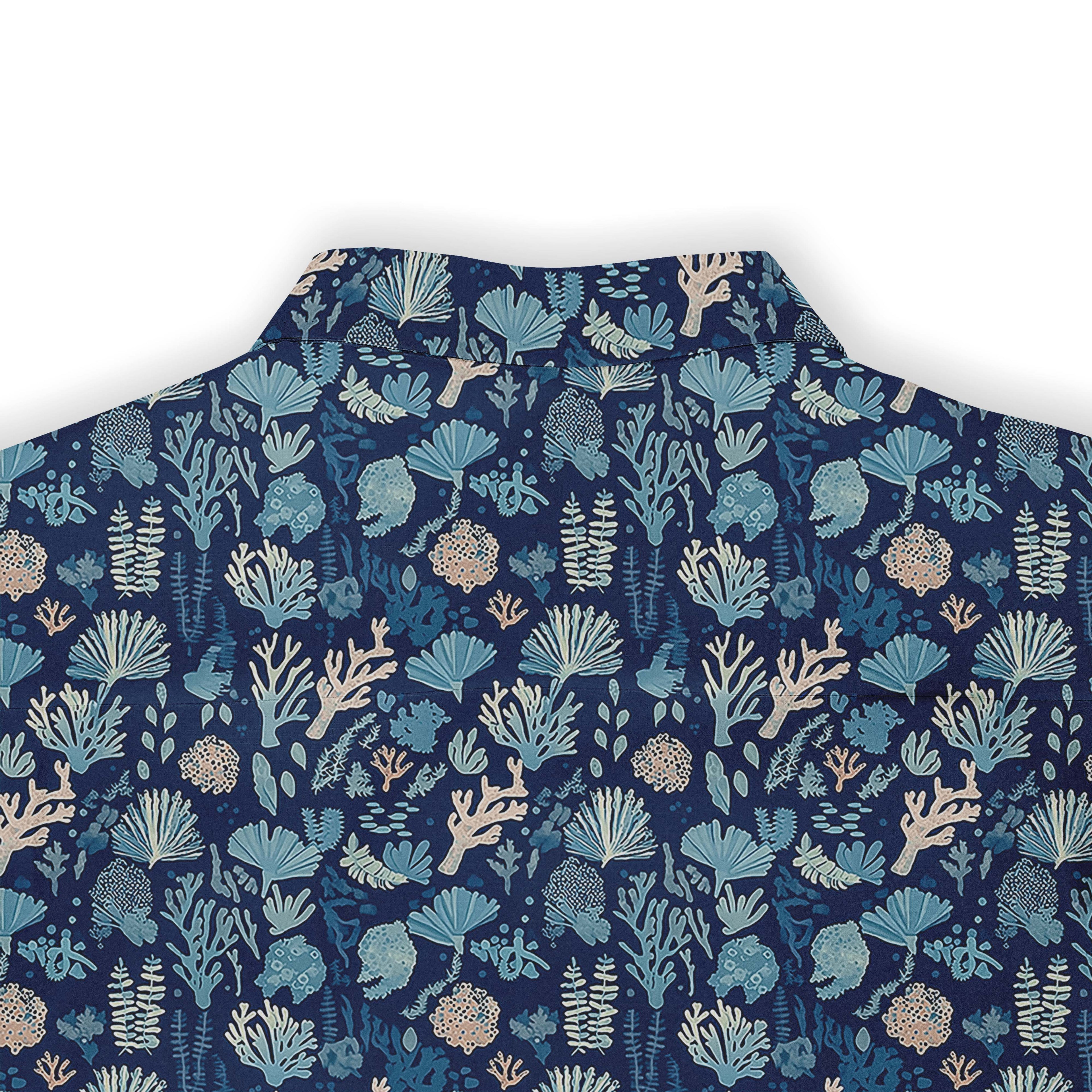 Blue shirt with coral and sea plant patterns.