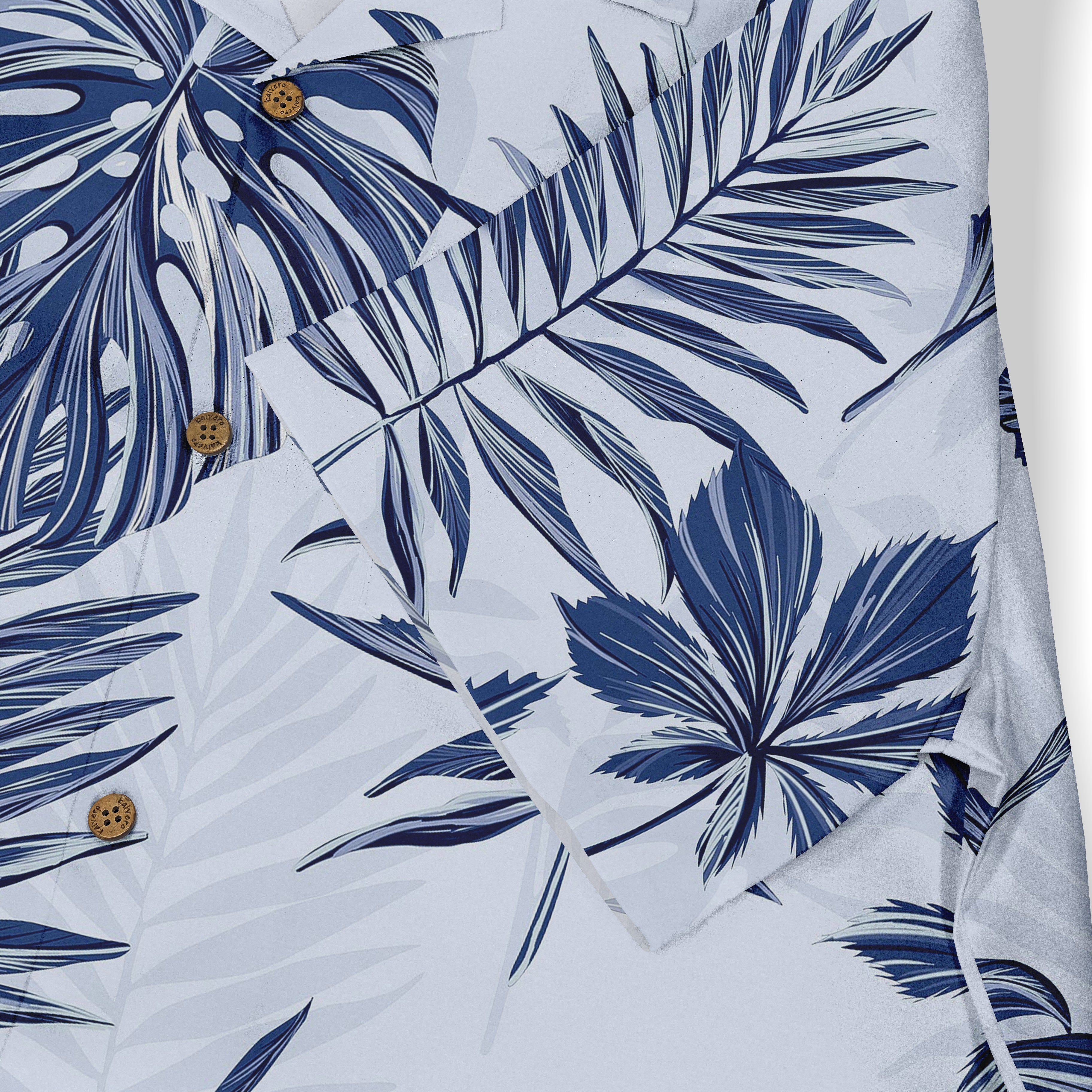White shirt with blue tropical leaf print and wooden buttons.