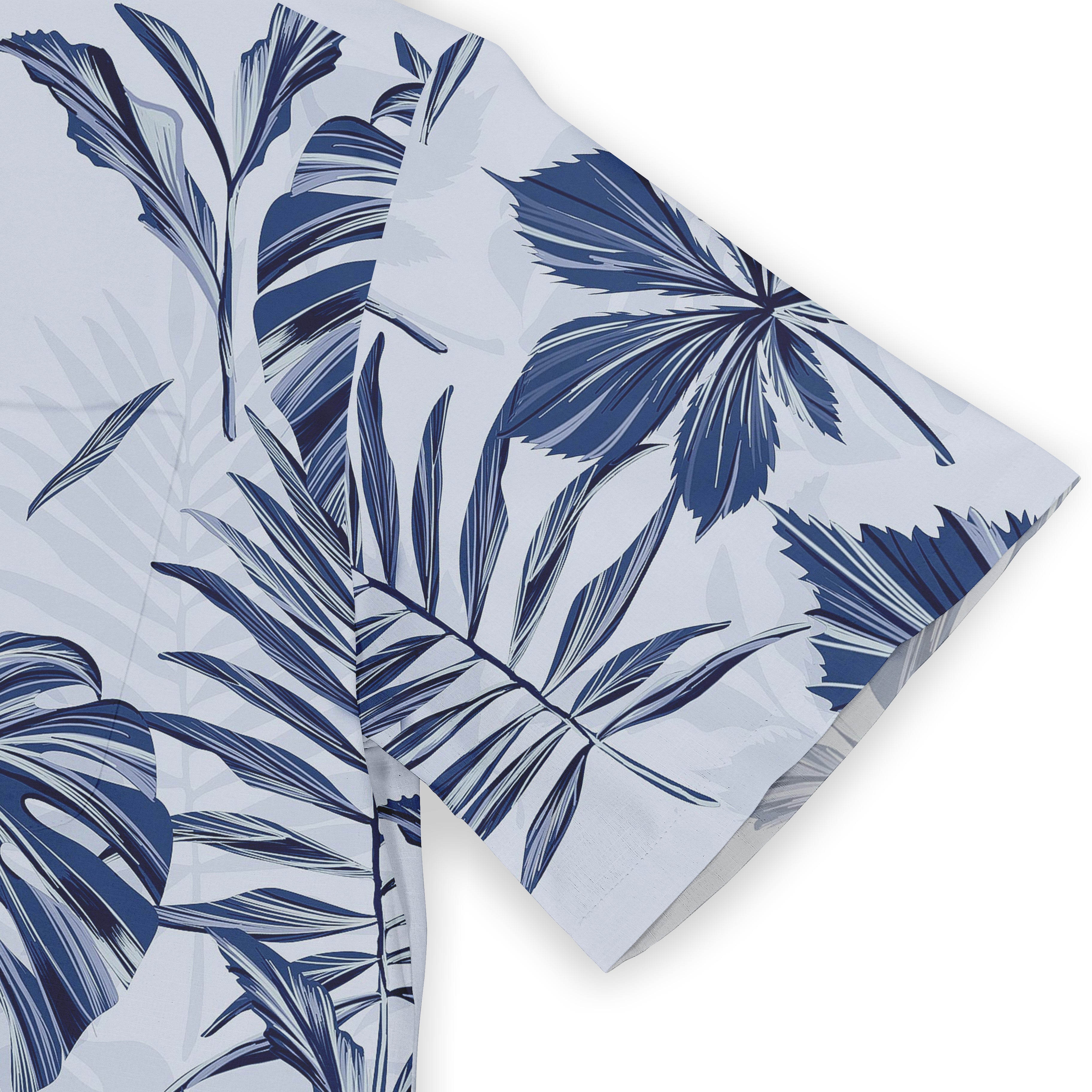 Blue tropical leaf pattern on light fabric, folded corner view.