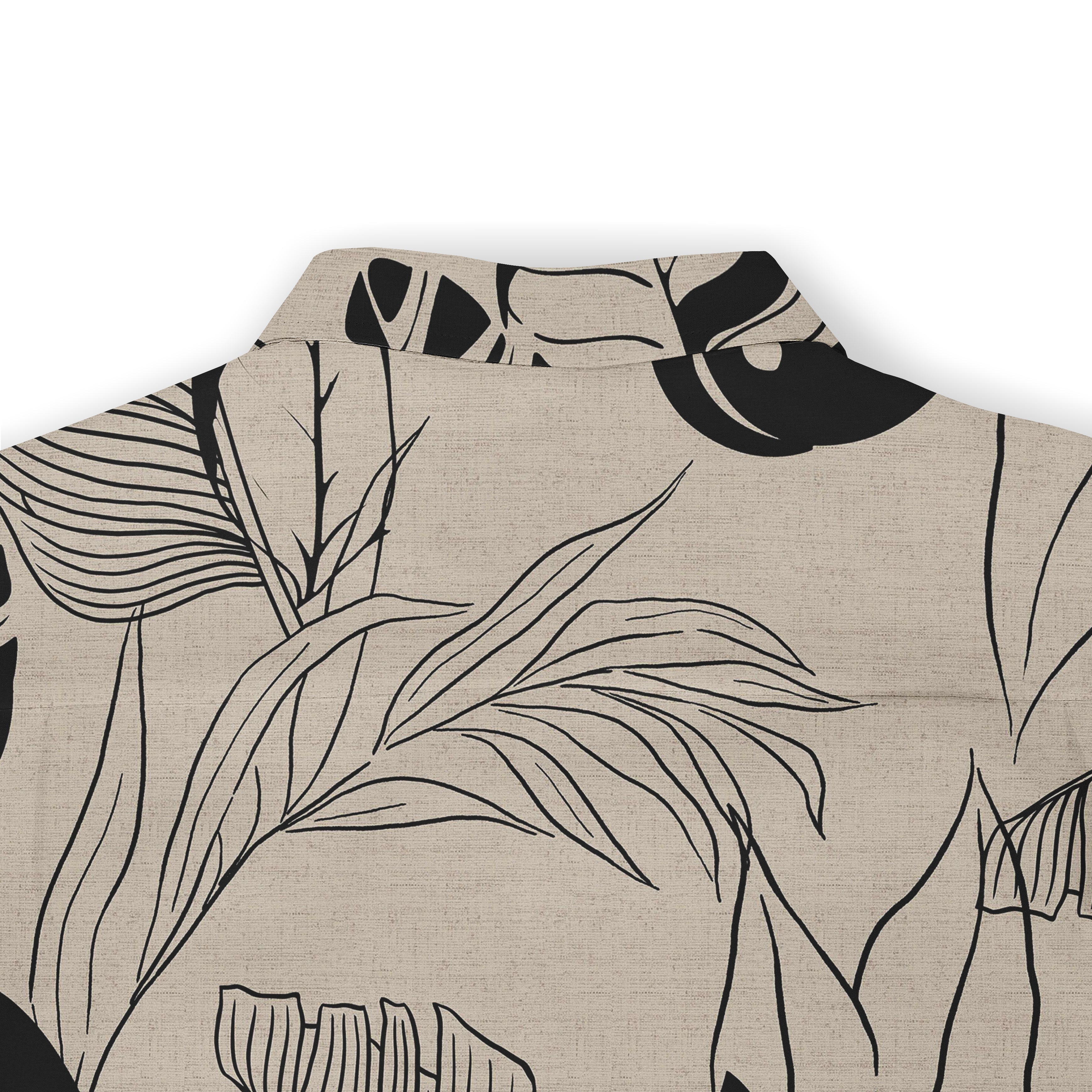 Beige shirt with black tropical leaf pattern, featuring a collar.