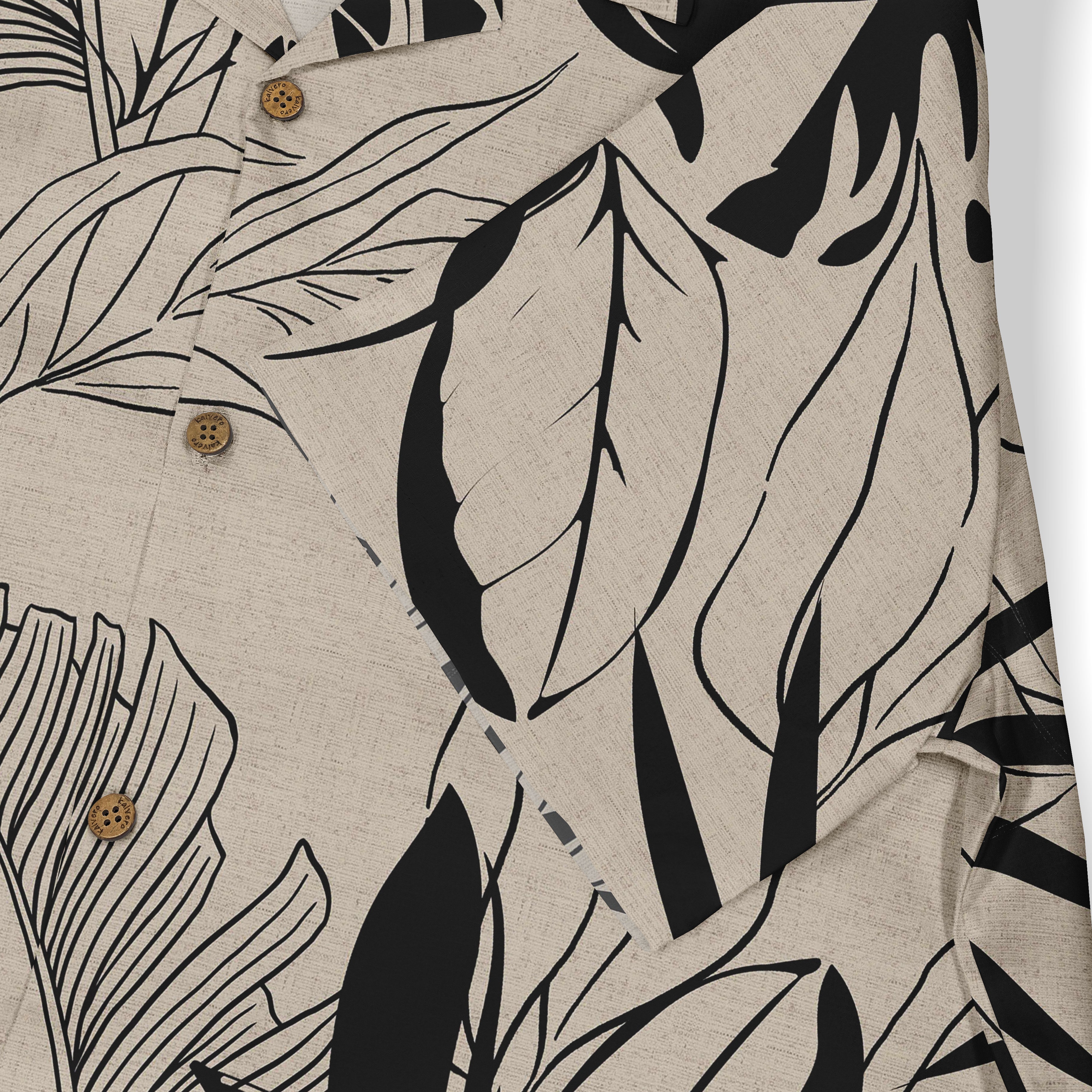 Beige shirt with black tropical leaf print and wooden buttons.