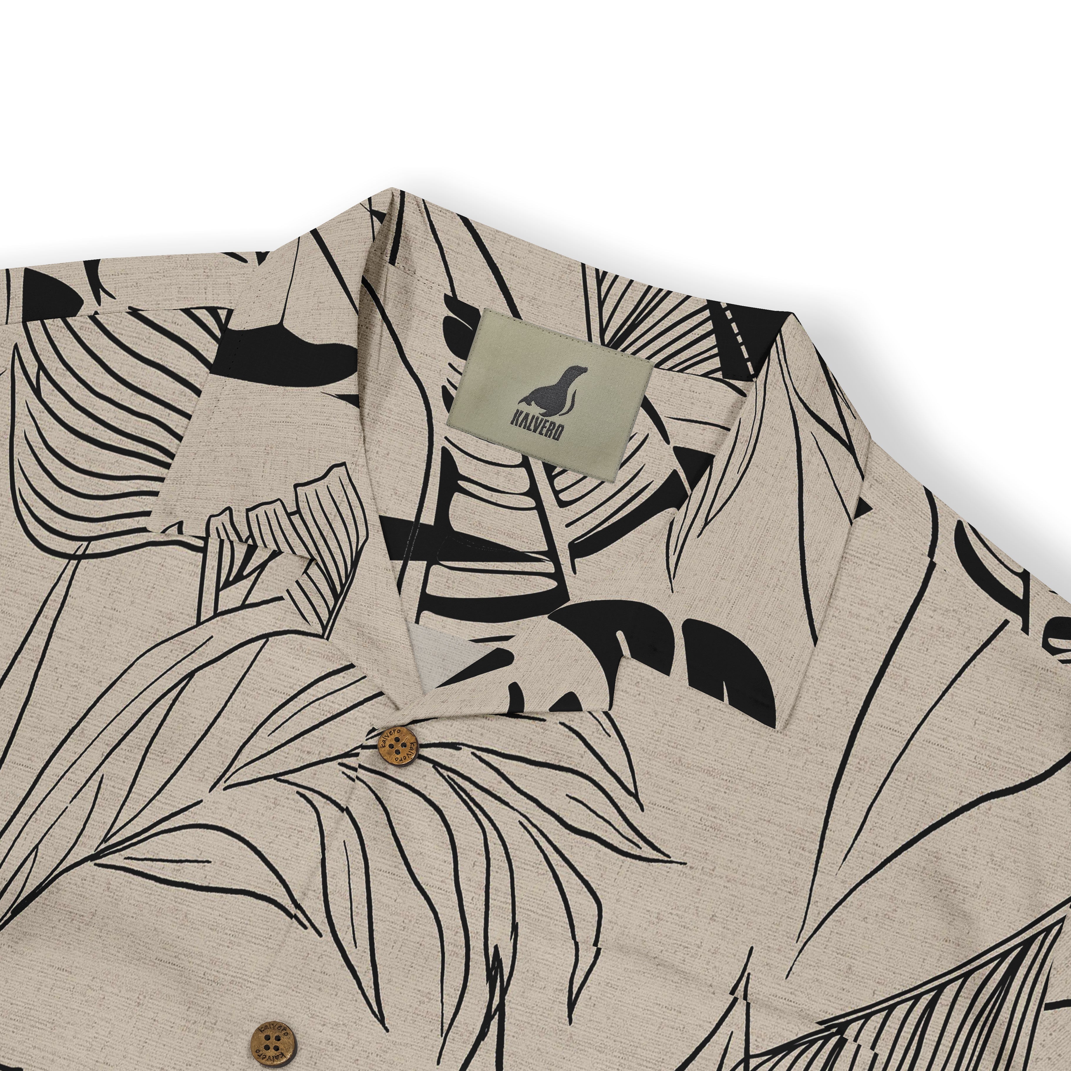 Beige shirt with black tropical leaf print, wooden buttons.