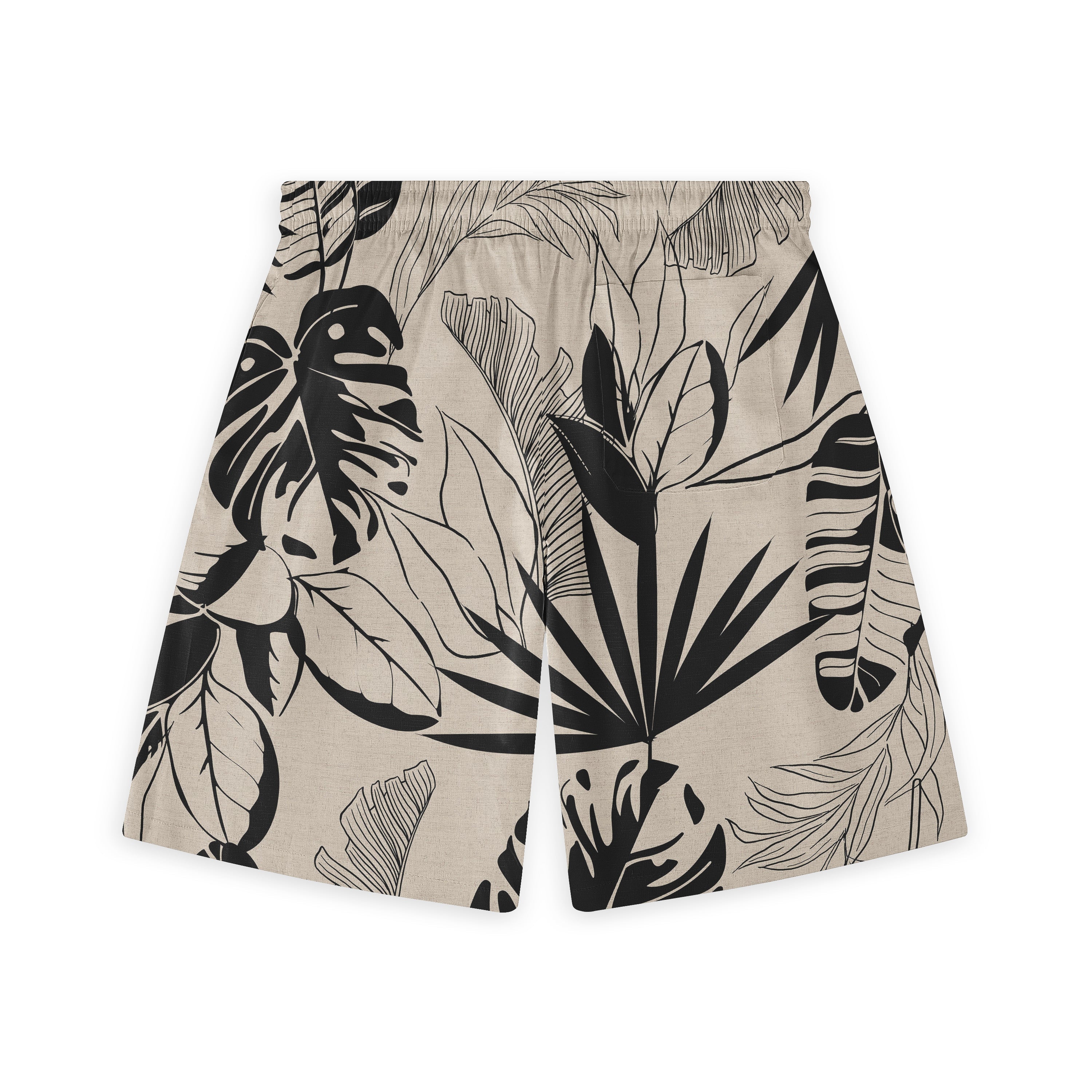 Beige shorts with black tropical leaf print, featuring a relaxed fit.