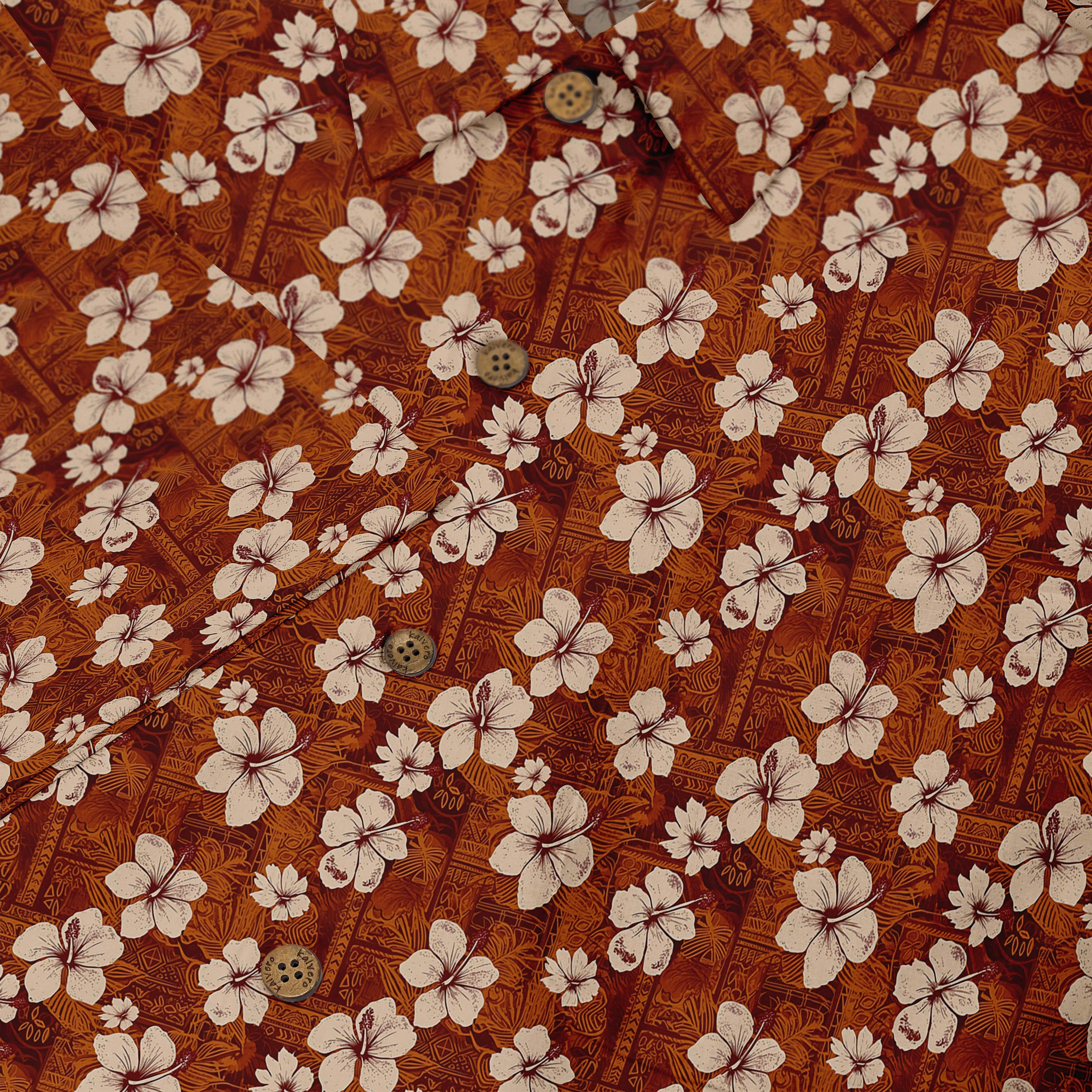Brown shirt with white hibiscus flowers and tribal patterns.