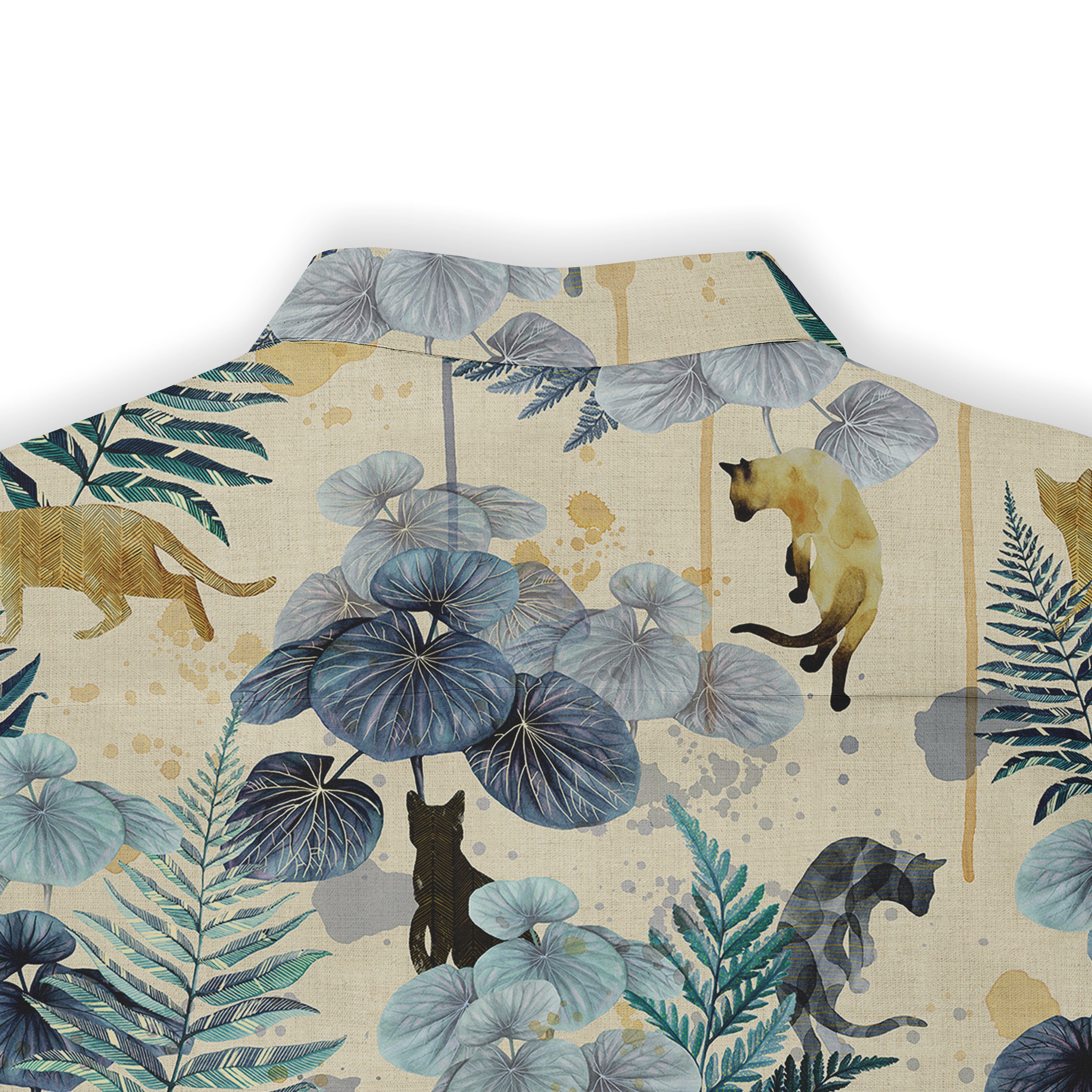 Shirt with cats, leaves, and tropical plants design.