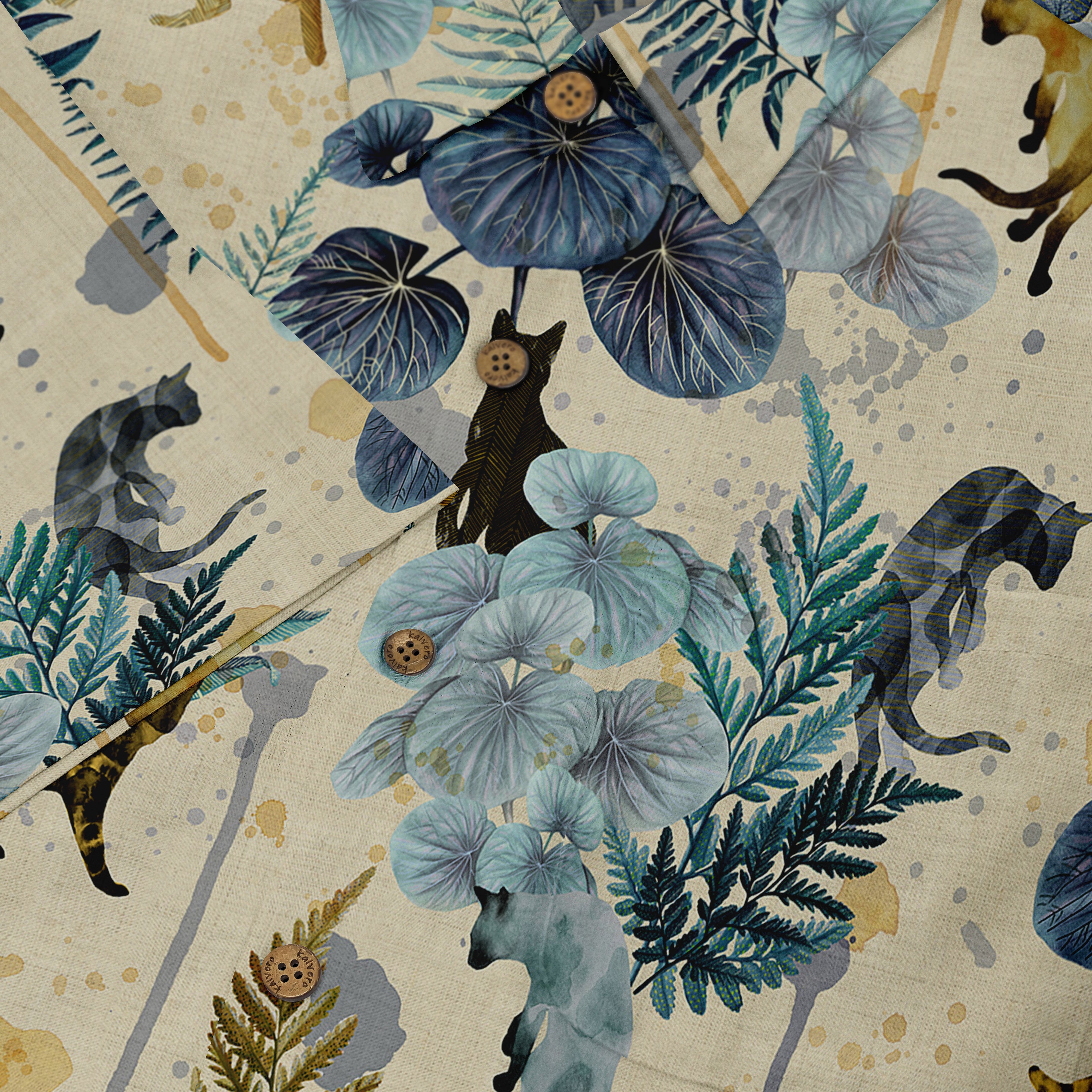 Fabric with cats, leaves, and buttons in blue and green tones.