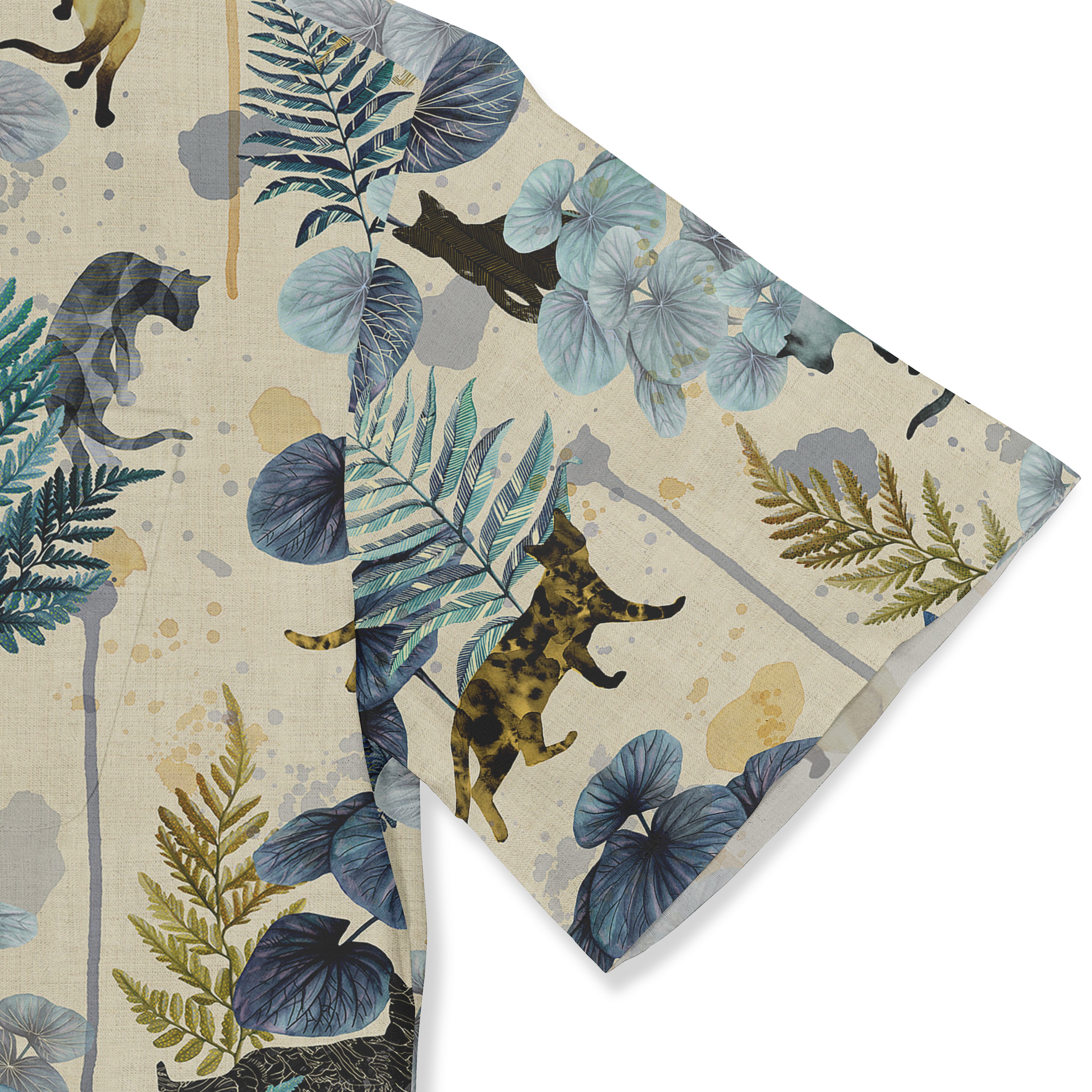 Fabric with cats, ferns, and blue leaves pattern.