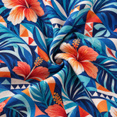 KALVERO Azure Hibiscus Mosaic Long Sleeve Shirt: fabric detail showing coral-orange and ivory hibiscus flowers, turquoise and pale-aqua palm leaves, and orange/cream geometric triangles and pinwheels over deep navy and azure blue.