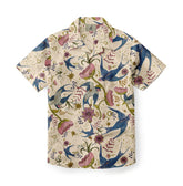 Cream short-sleeve shirt with blue birds, pink flowers, and green.