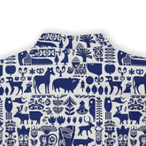 Blue and white fabric with animal and plant patterns.