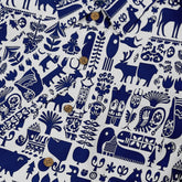 Blue and white patterned fabric with animals and plants.