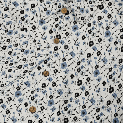 Floral print shirt with blue and black flowers on white fabric.