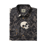 Dark floral shirt with skull print, brown buttons, and brand tag.