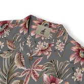 Gray floral shirt with vibrant tropical print, wooden buttons.