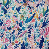 Colorful floral pattern shirt with wooden buttons on white background.