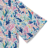 Colorful coral and seaweed pattern on a white fabric.