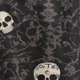 Black fabric with skull and floral pattern, featuring a pocket.