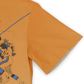 Orange T-shirt with blue and black graphic of a running figure.