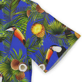 Tropical print fabric with toucans, pineapples, coconuts, and palm.