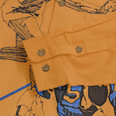 Orange shirt with graphic print, buttoned cuffs, and branded buttons.
