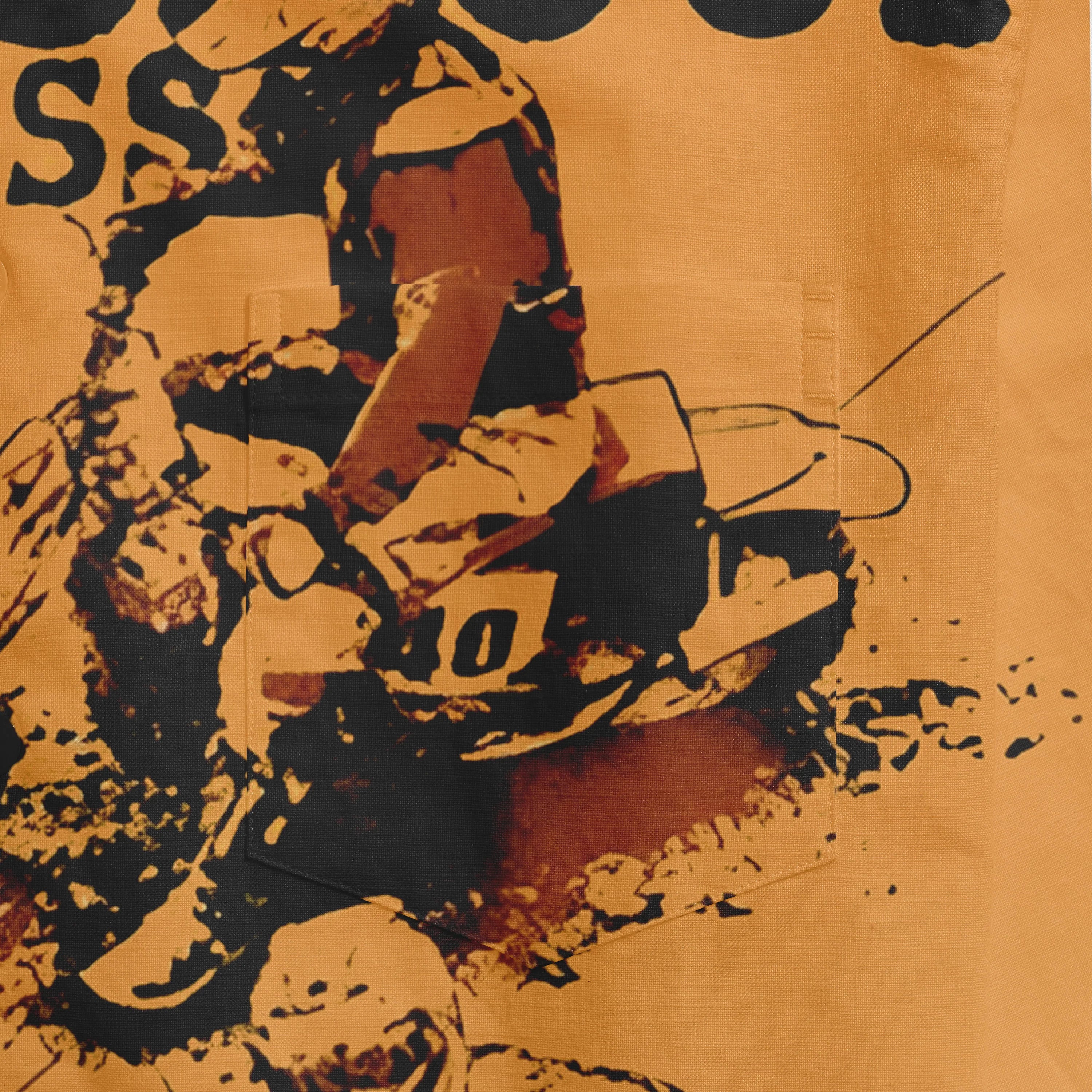 Orange fabric with black and white graphic print of a motorcycle.