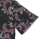 Black silk scarf with intricate red, purple, and white paisley.