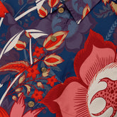 Vibrant floral shirt with bold red, pink, and blue patterns.