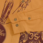 Orange shirt with maroon graphic print, featuring buttons and cuff.