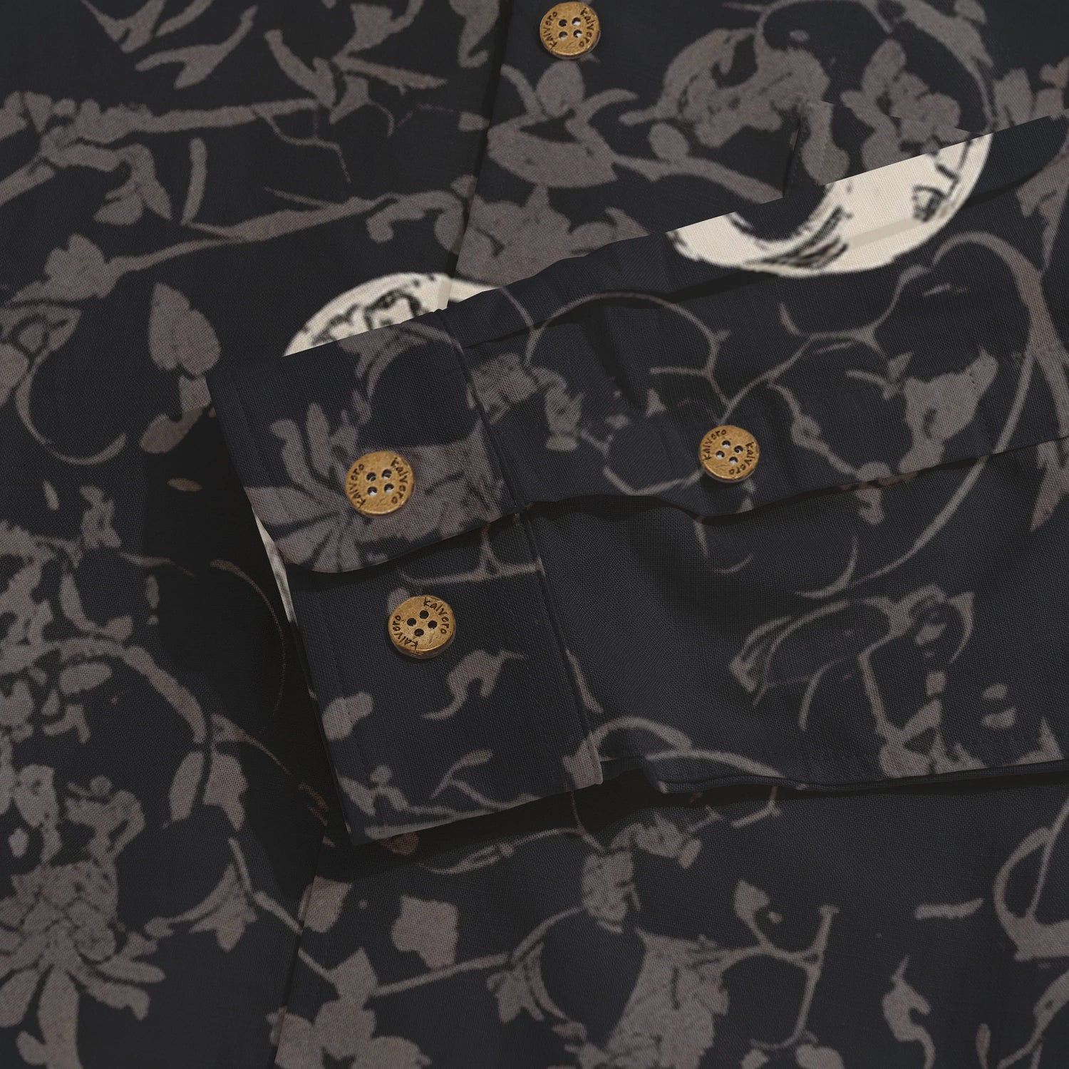 Dark floral-patterned shirt with wooden buttons and detailed cuff.