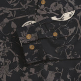 Dark floral-patterned shirt with wooden buttons and detailed cuff.