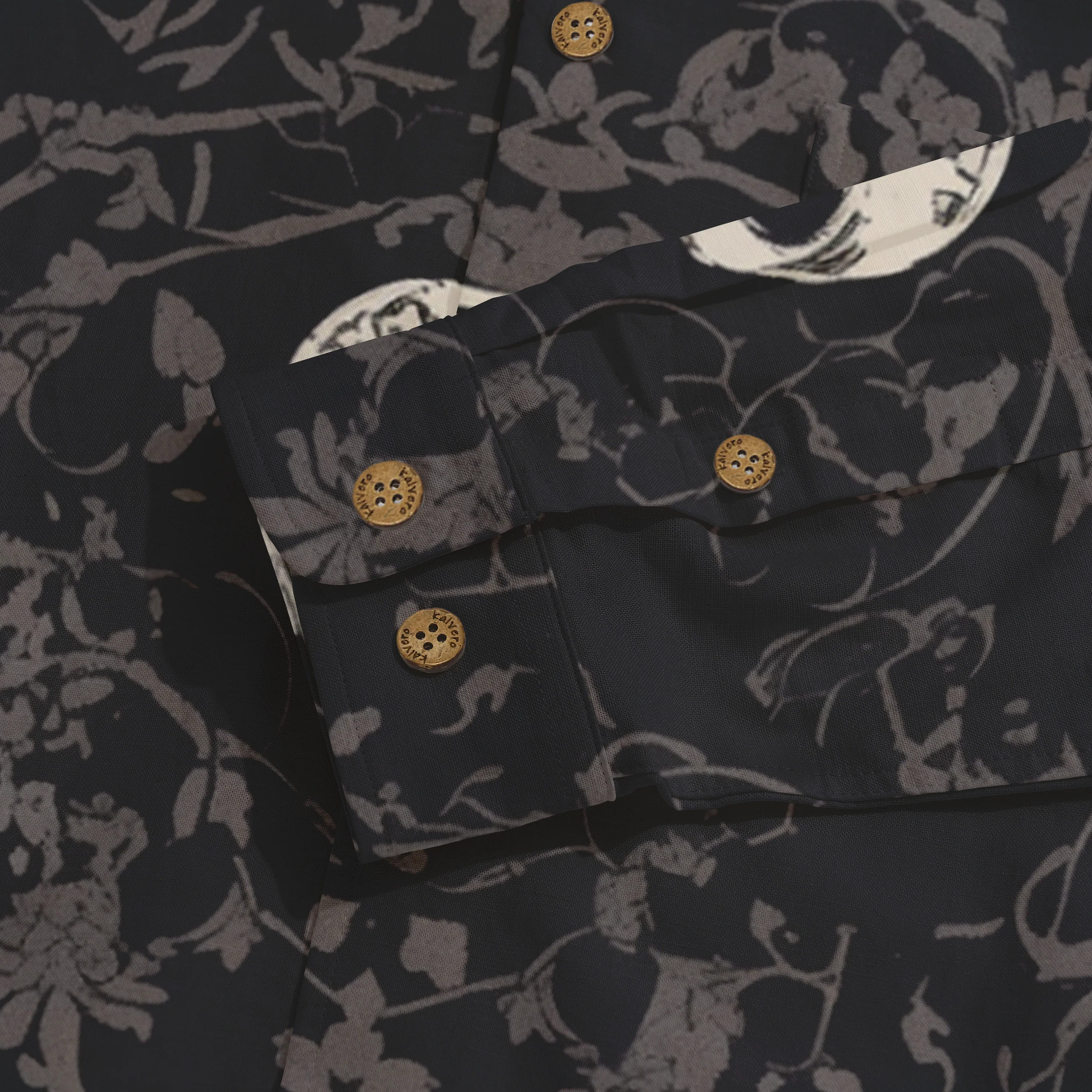 Dark floral-patterned shirt with wooden buttons and detailed cuff.