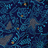 Dark blue shirt with vibrant turquoise floral patterns and wooden.